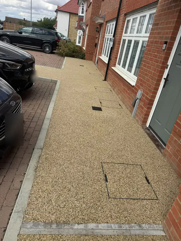 Resin bound front path alongside a brick house