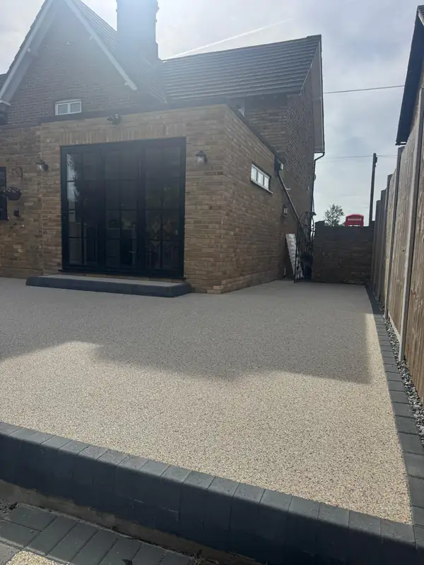 Resin bound patio outside black-framed bifold doors