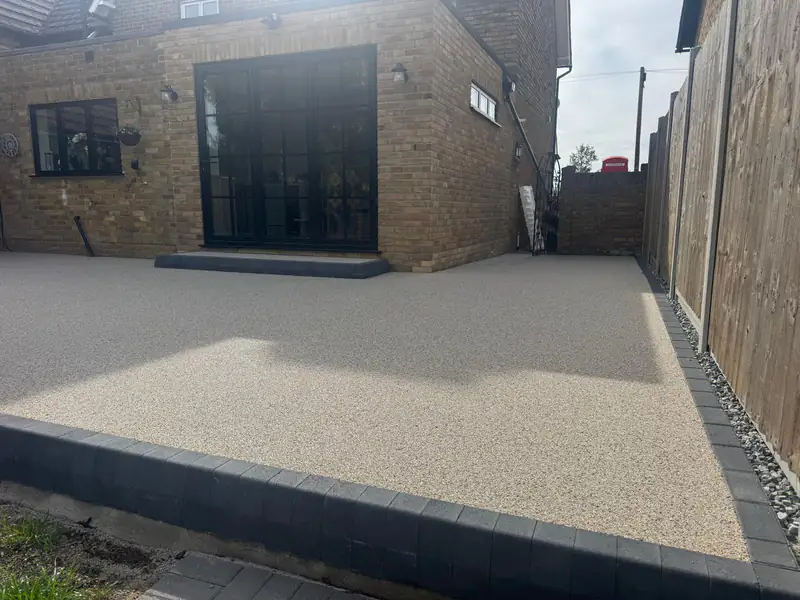 Resin bound patio outside bifold doors with a dark border edging
