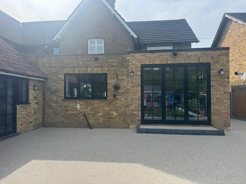 Resin bound patio across the back of an extension with bifold doors
