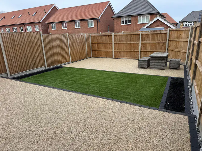 Resin bound patio meeting a lawn, with a second seating area beyond