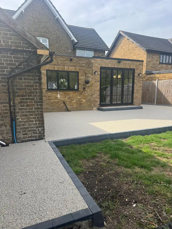 Resin bound patio running from the side of the house to the back garden
