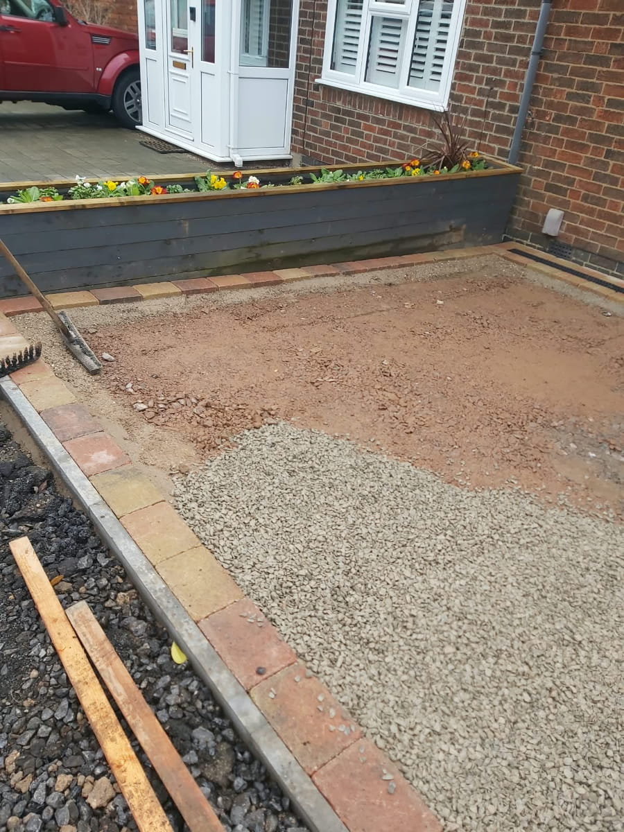 Front garden dug out to bare ground, with the stone sub-base starting to go down and block edging along the side
