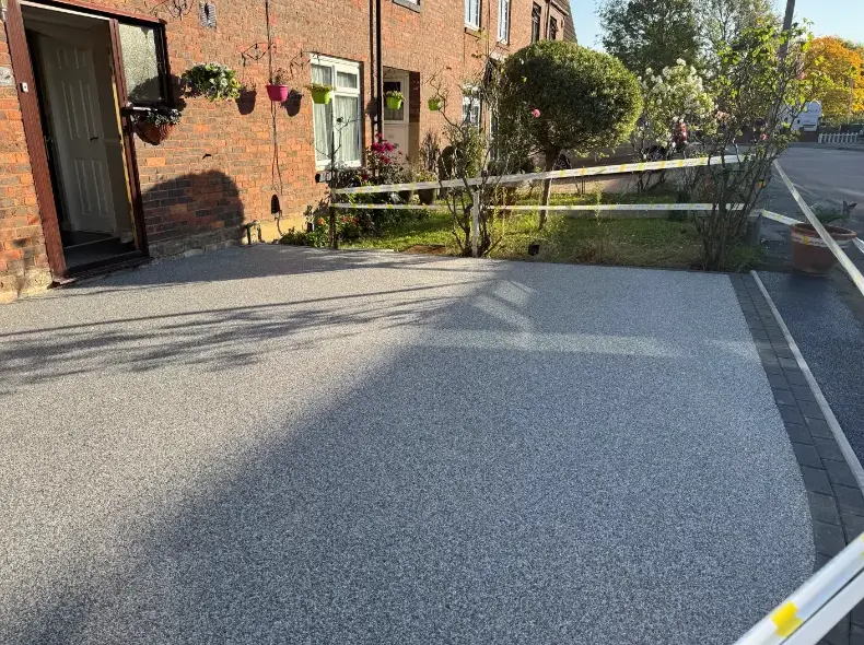 kent-resin-driveways-grey-resin-driveway-brick-house-baskets