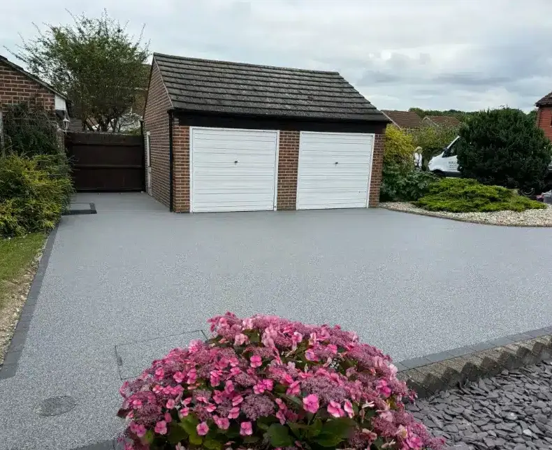 kent-resin-driveways-grey-resin-driveway-white-garage-flowers