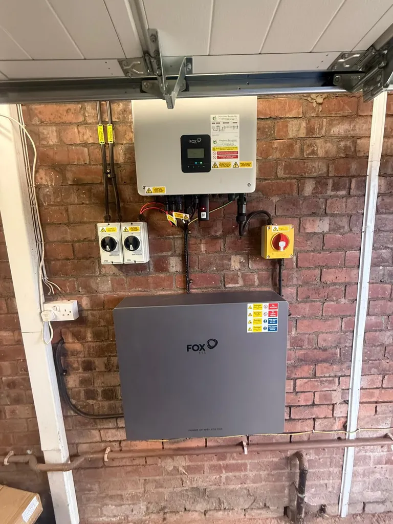Fox ESS hybrid inverter and ECS battery installed on brick wall — Greater Manchester