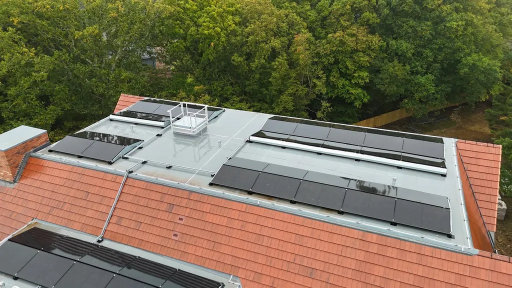 Commercial solar panels on care home roof — drone view, Manchester