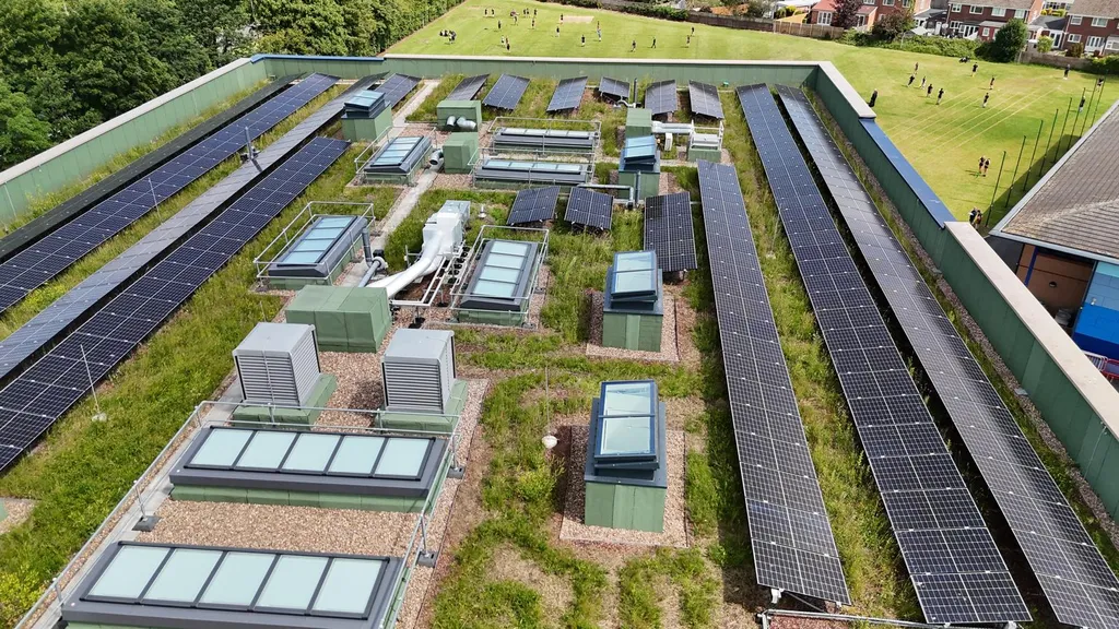 Commercial solar panels on green roof — large building, Manchester