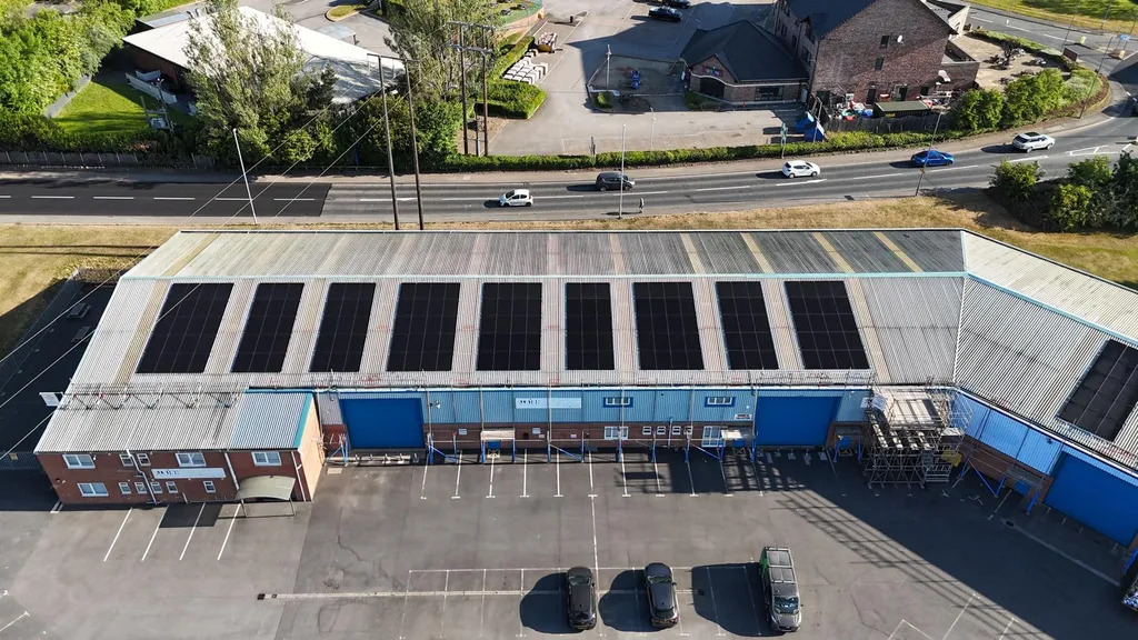 Commercial solar PV system on warehouse — overhead drone, Manchester