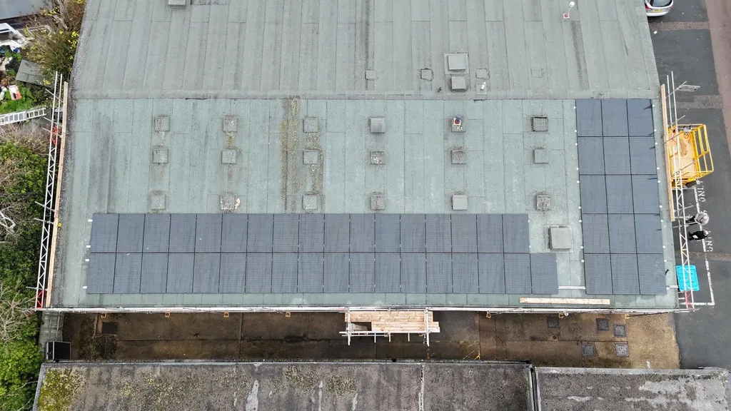 Community building solar panels — flat roof installation, Manchester