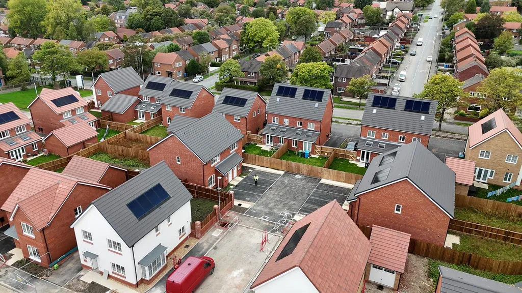 Completed new-build estate with solar panels in summer, Manchester