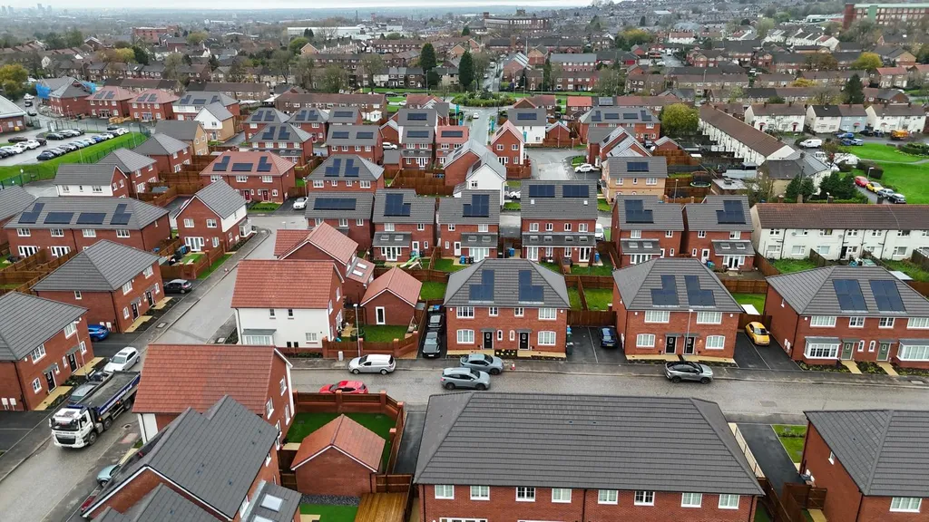 Dense housing estate with solar panels — high altitude drone, Manchester