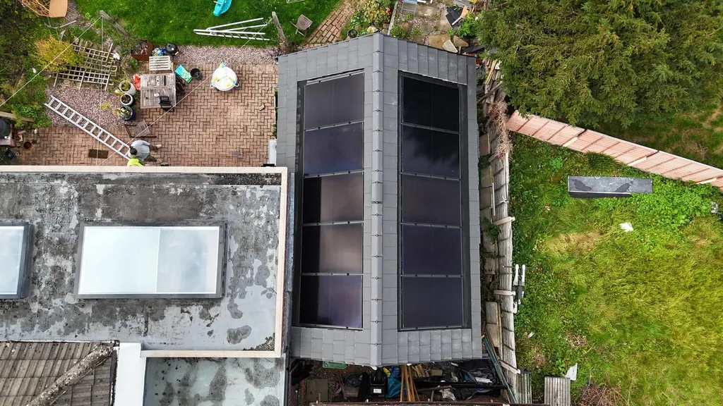 Domestic solar installation on contemporary extension — drone, Manchester