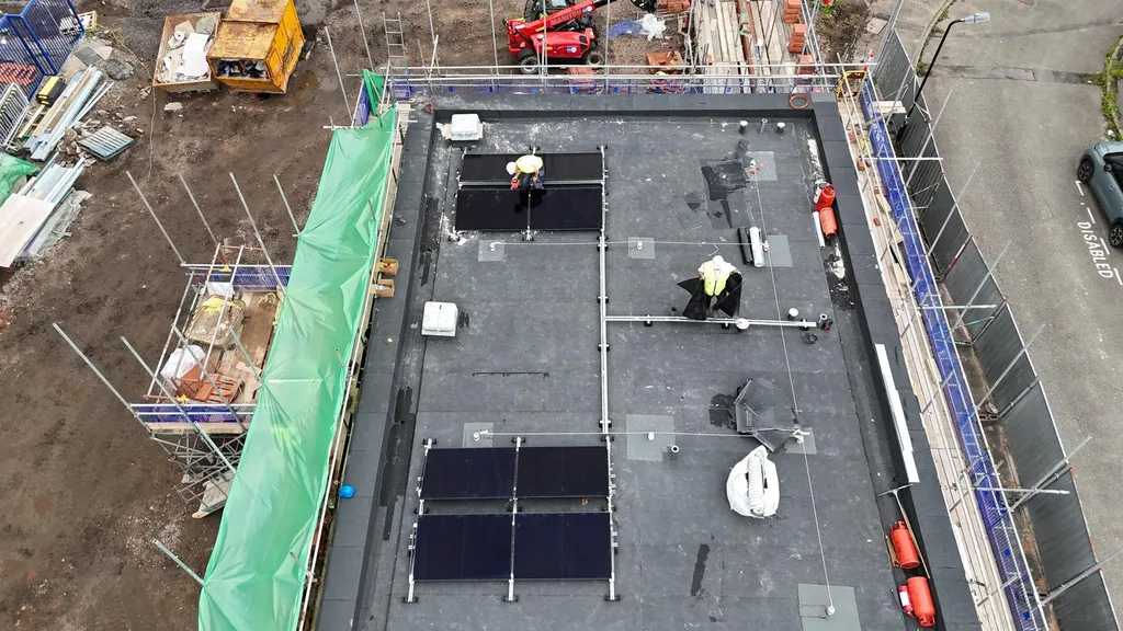 Flat roof solar panel installation on Manchester commercial building