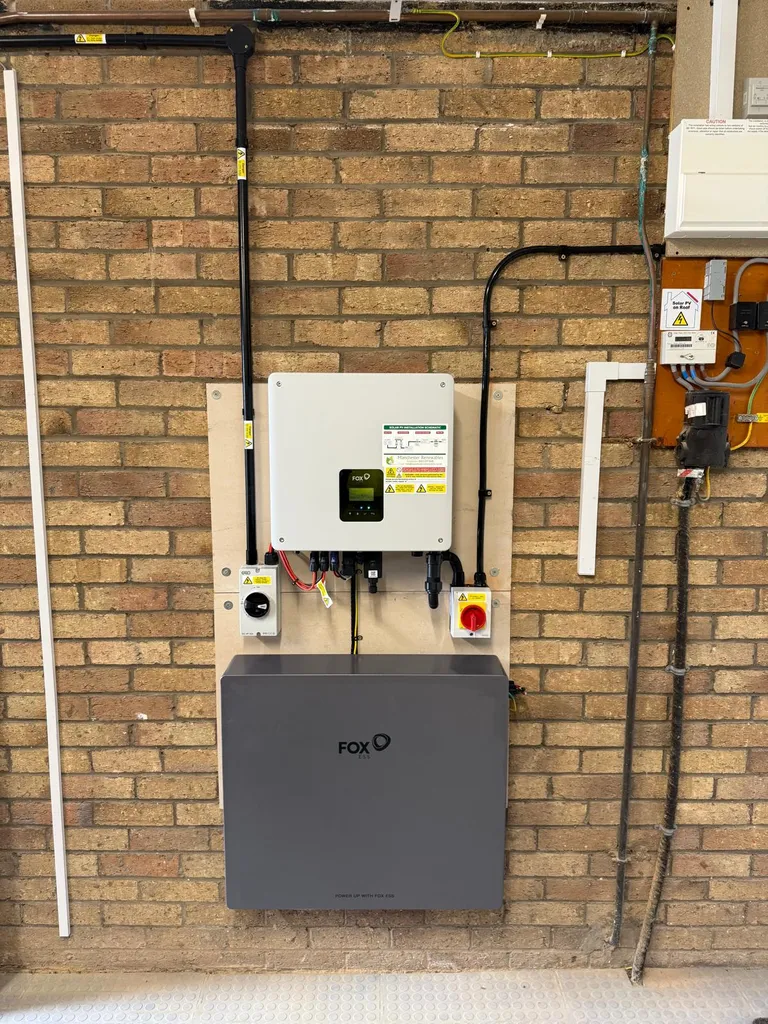 Fox ESS inverter and battery on brick wall — Manchester Renewables