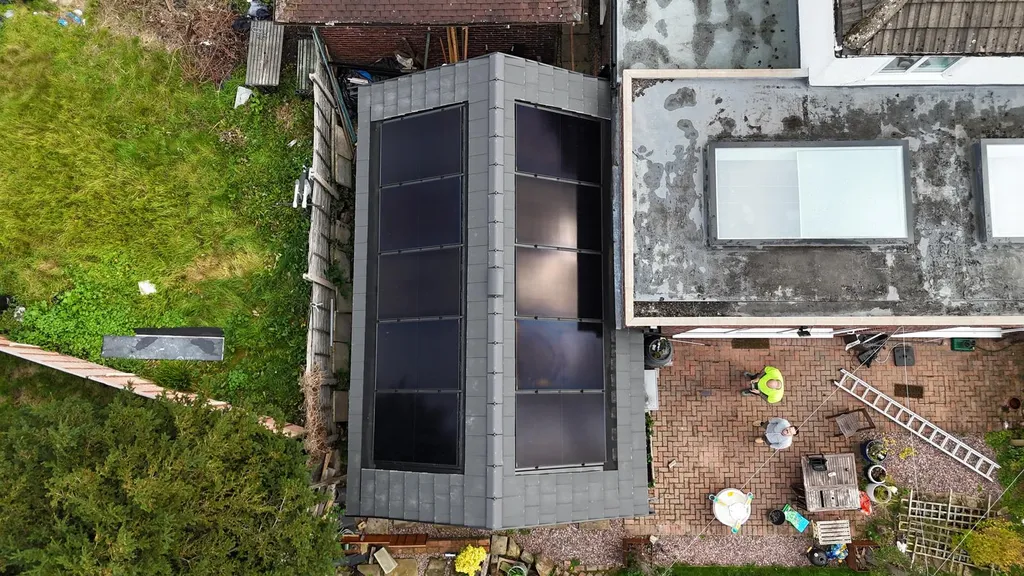 Home solar panels on modern flat roof extension, Manchester