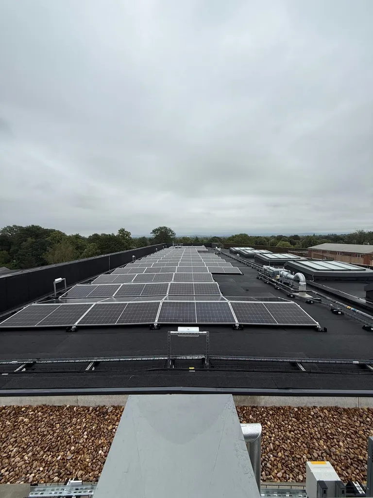 Large commercial solar array on flat roof — rooftop view, Manchester