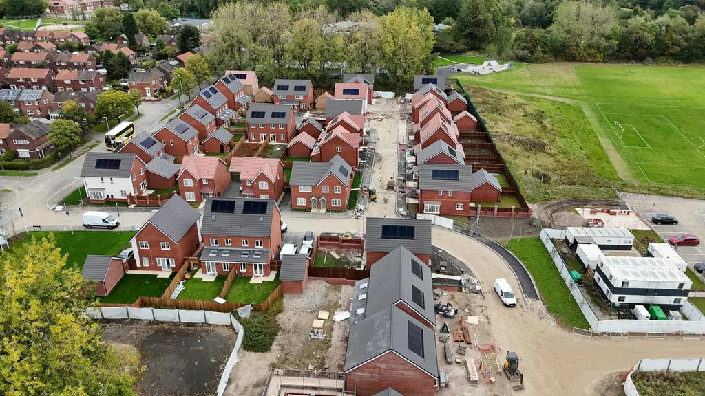 Large new-build estate with solar panels — high altitude, Manchester