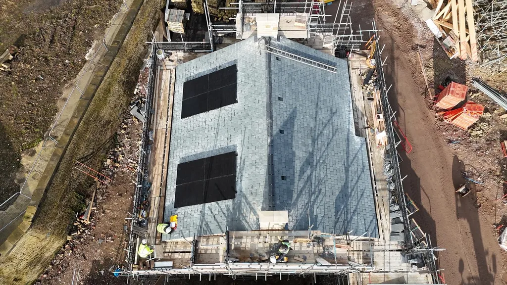 New-build block with in-roof solar — construction overhead, Manchester