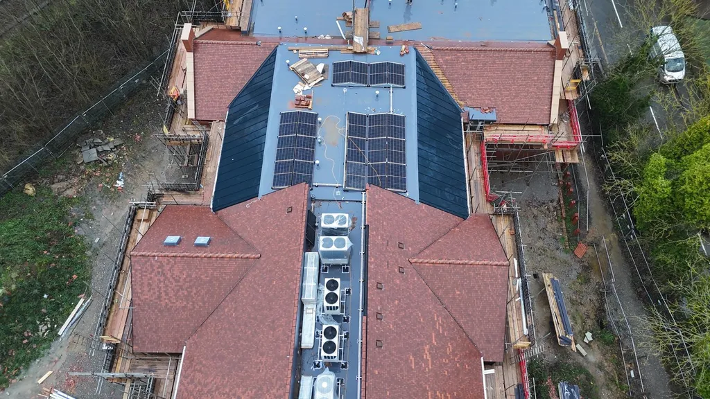 New-build care home solar panels — flat roof aerial, Manchester