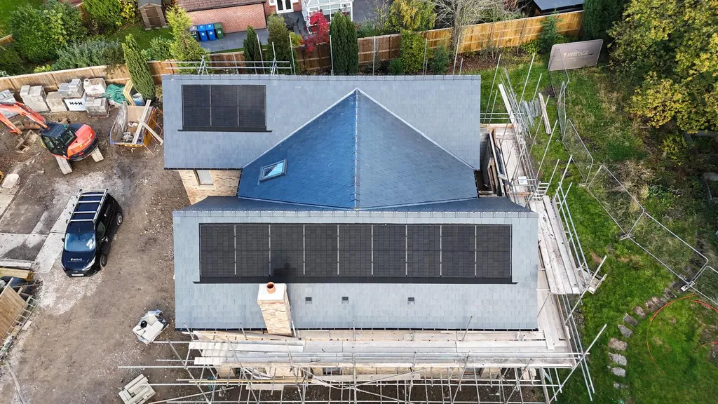 New-build domestic solar panels on detached house — drone, Manchester