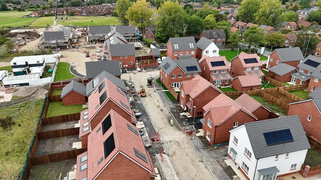 New-build homes with solar panels — mixed roof tiles drone, Manchester