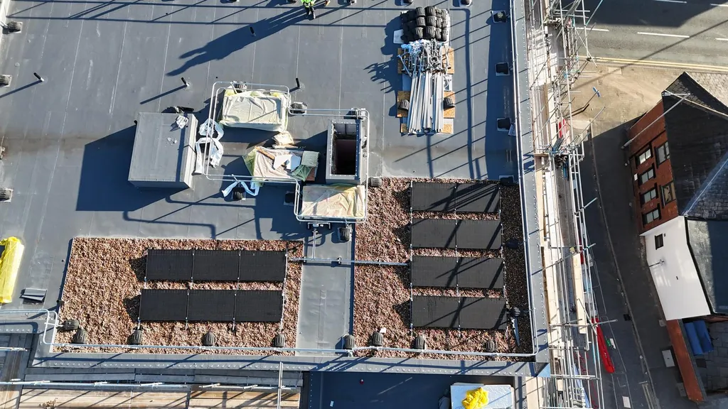Small commercial solar installation on gravel flat roof, Manchester