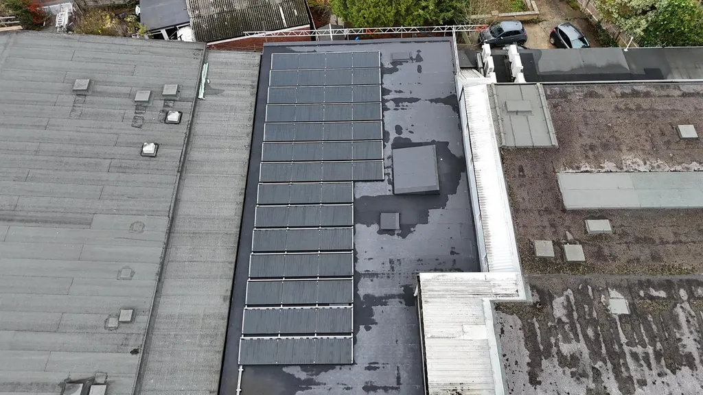 Small commercial solar panels on flat roof membrane, Manchester