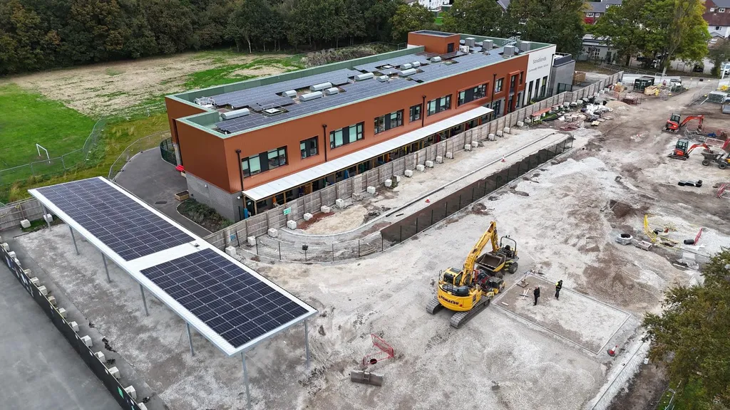 Solar panels on school building — Manchester Renewables drone shot