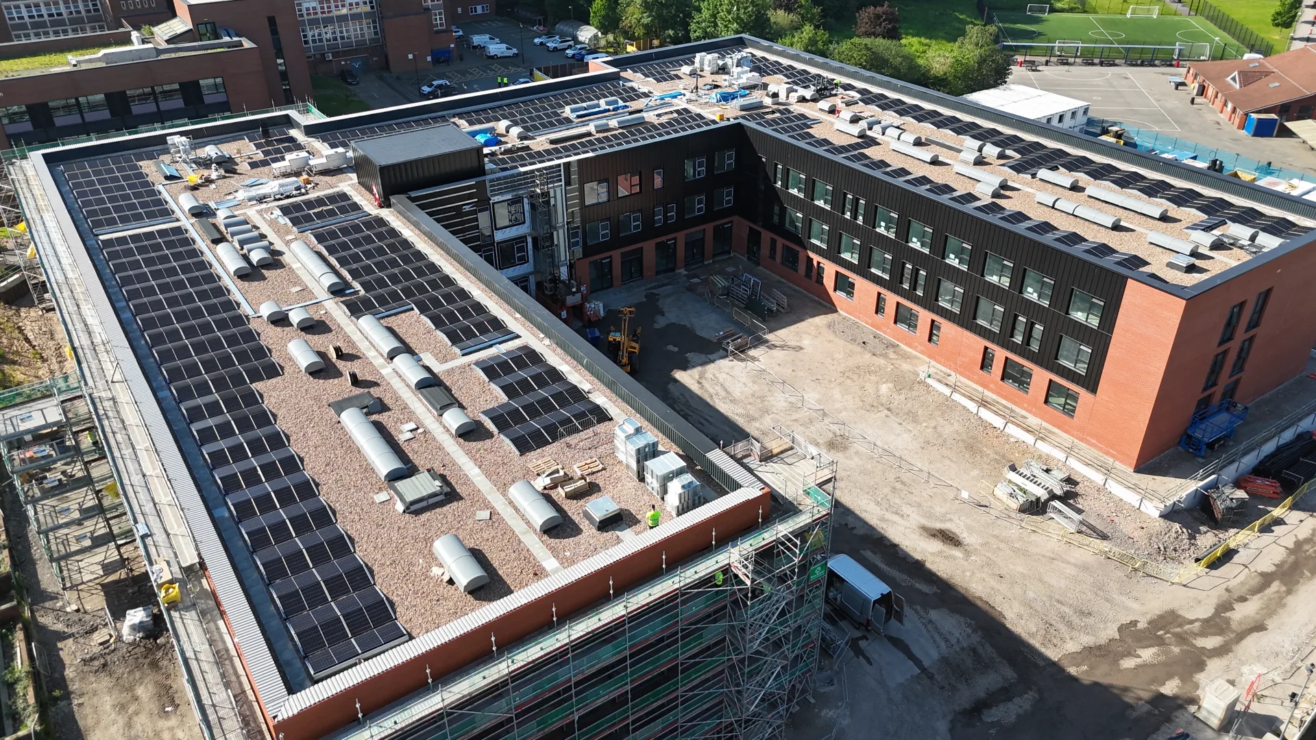 Second view of the Wigan & Leigh College 330 kW commercial solar PV installation on the main building flat roof.