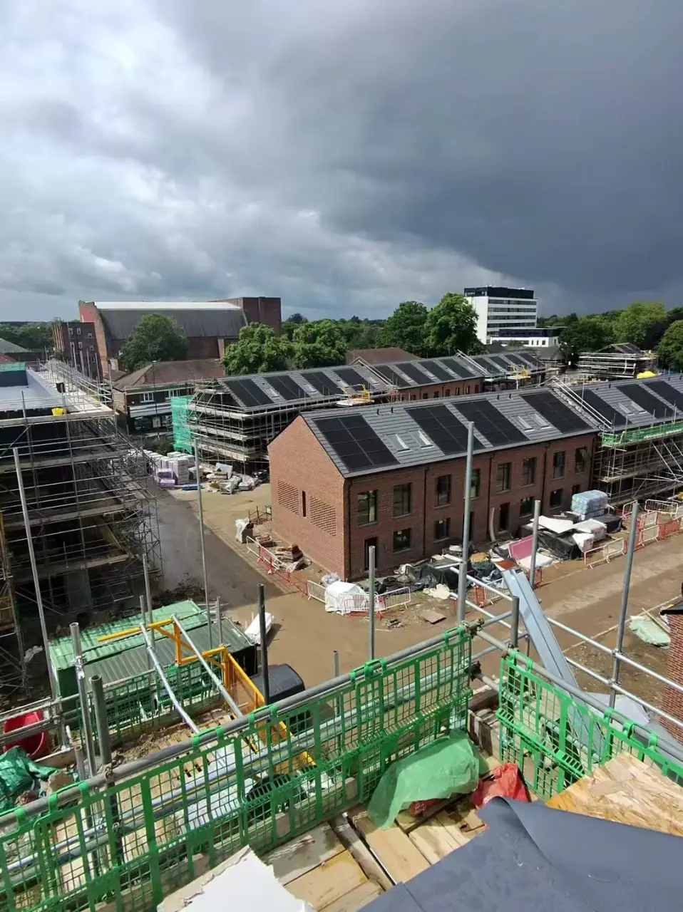 Jordan from Manchester Renewables on-site at the Sale new-build development, walking through the solar PV installation — 425W Solfit panels across 46 houses and the apartment-block array on Esdec frames.