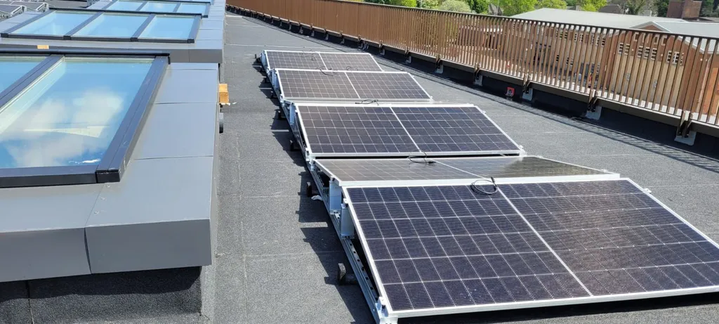 Completed 80kW college solar installation in Greater Manchester — full roof aerial shot