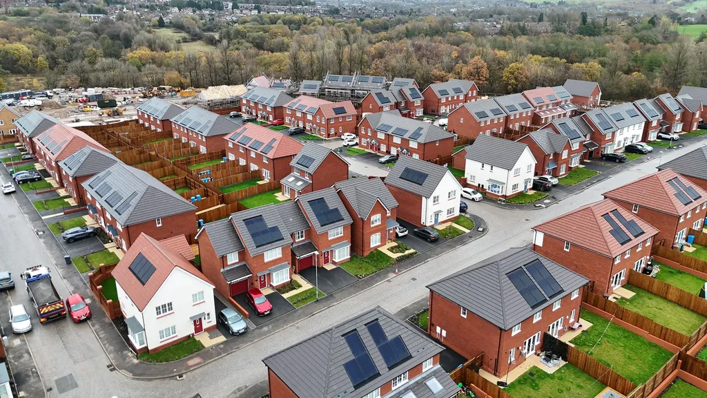New-build solar installation Oldham — drone shot of completed homes with solar PV