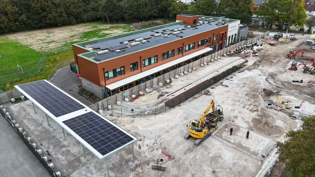 Primary school solar installation during construction phase — drone shot showing panel layout