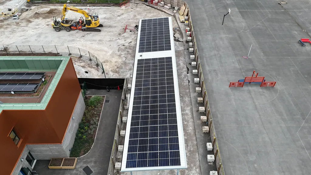 New-build primary school with solar panels — aerial view by Manchester Renewables