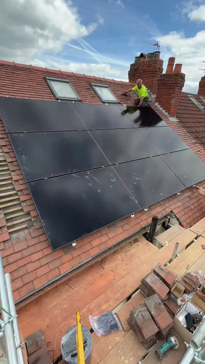 Time-lapse of a Manchester Renewables domestic solar panel installation — mounting rails fitted to a tiled pitched roof, then an all-black on-roof array installed.