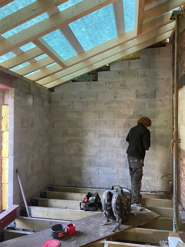 Inside the rear extension during first-fix electrical work — cables run, back boxes fitted, ready for plastering