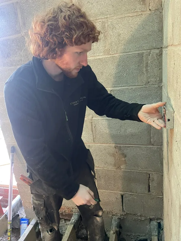 Steels Electrical engineer carrying out first-fix electrical work on a Heaton Mersey extension