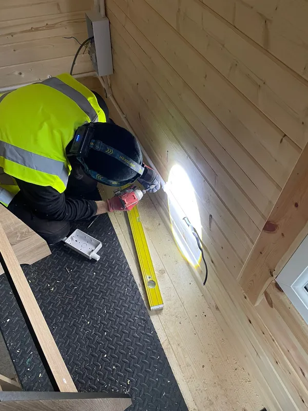 Steels Electrical engineer working on a garden office power and lighting installation in Sale, Trafford