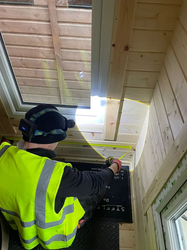 Interior of a garden office during electrical first fix in Sale — conduit and cable runs