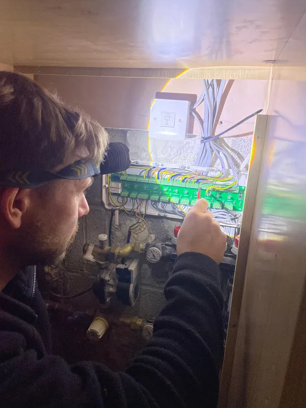 Steels Electrical engineer fault-finding on a Heatmiser underfloor heating wiring centre in Bramhall, Stockport