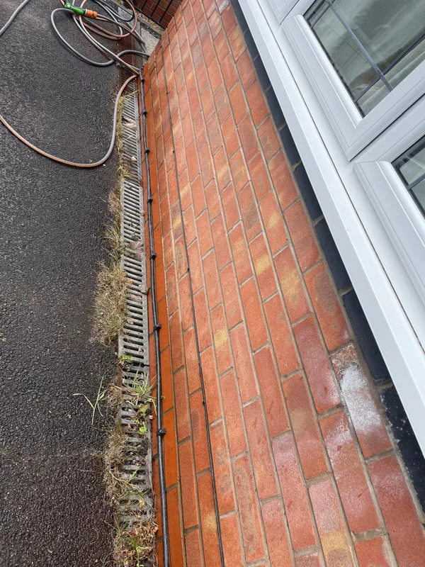 6mm SWA cable run along an external brick wall feeding the new OHME EV charger in Stalybridge