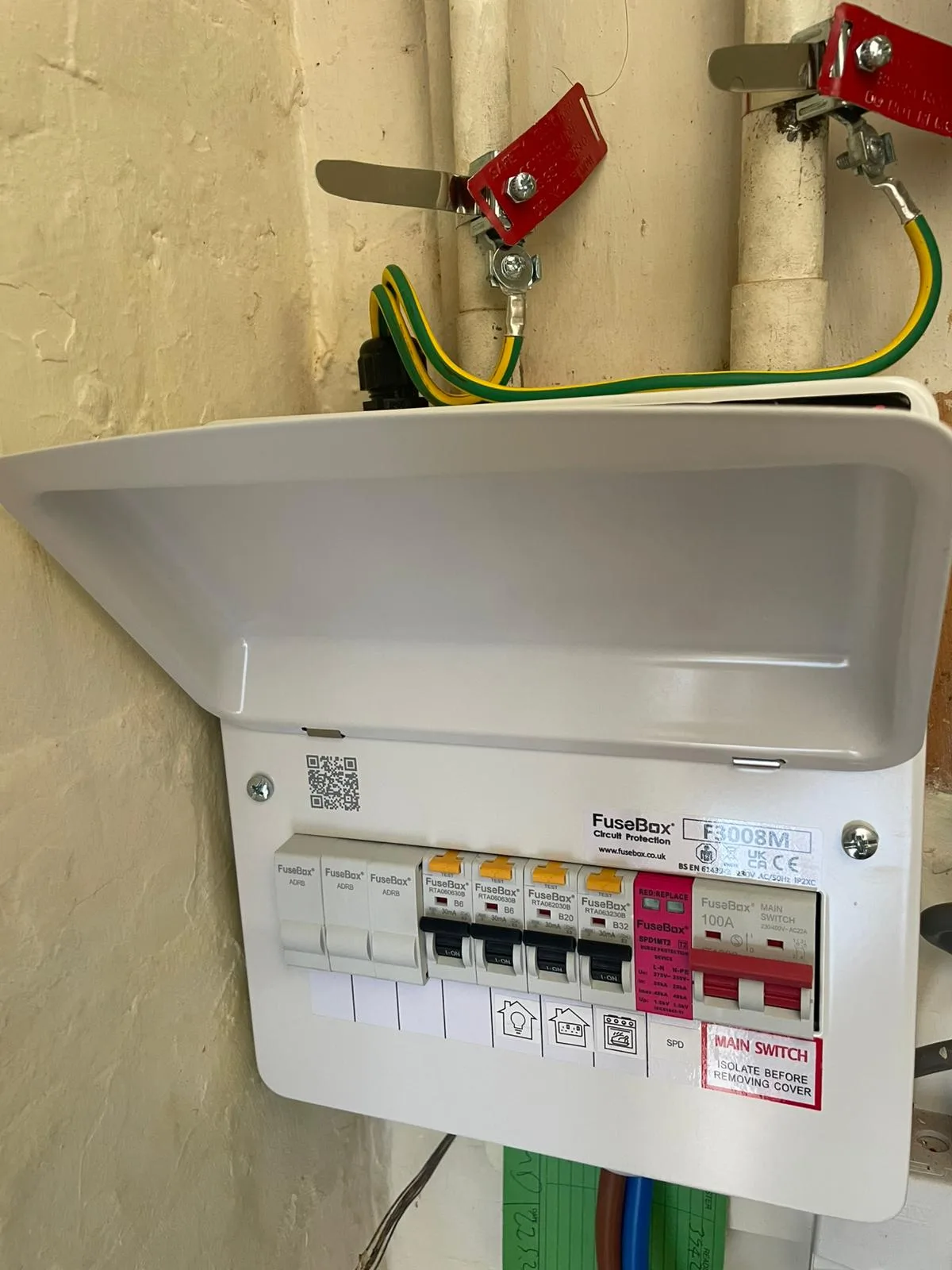New 18th Edition consumer unit fitted in Hattersley by Steels Electrical — individual RCBOs, a surge protection device (SPD) and a 100A main switch, board open before the cover went on