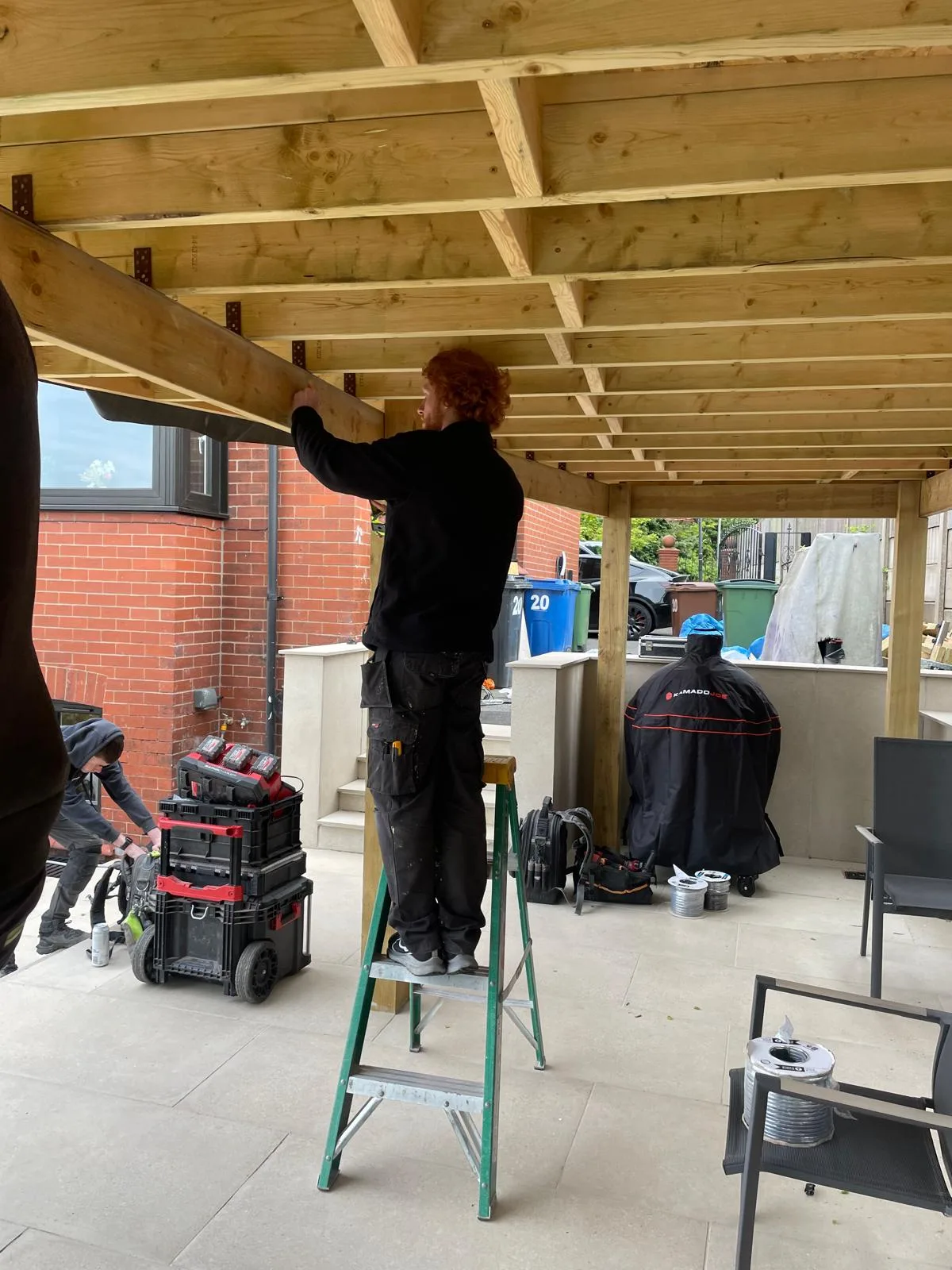 First-fix electrical work in the timber roof joists of a new garden room in Hyde