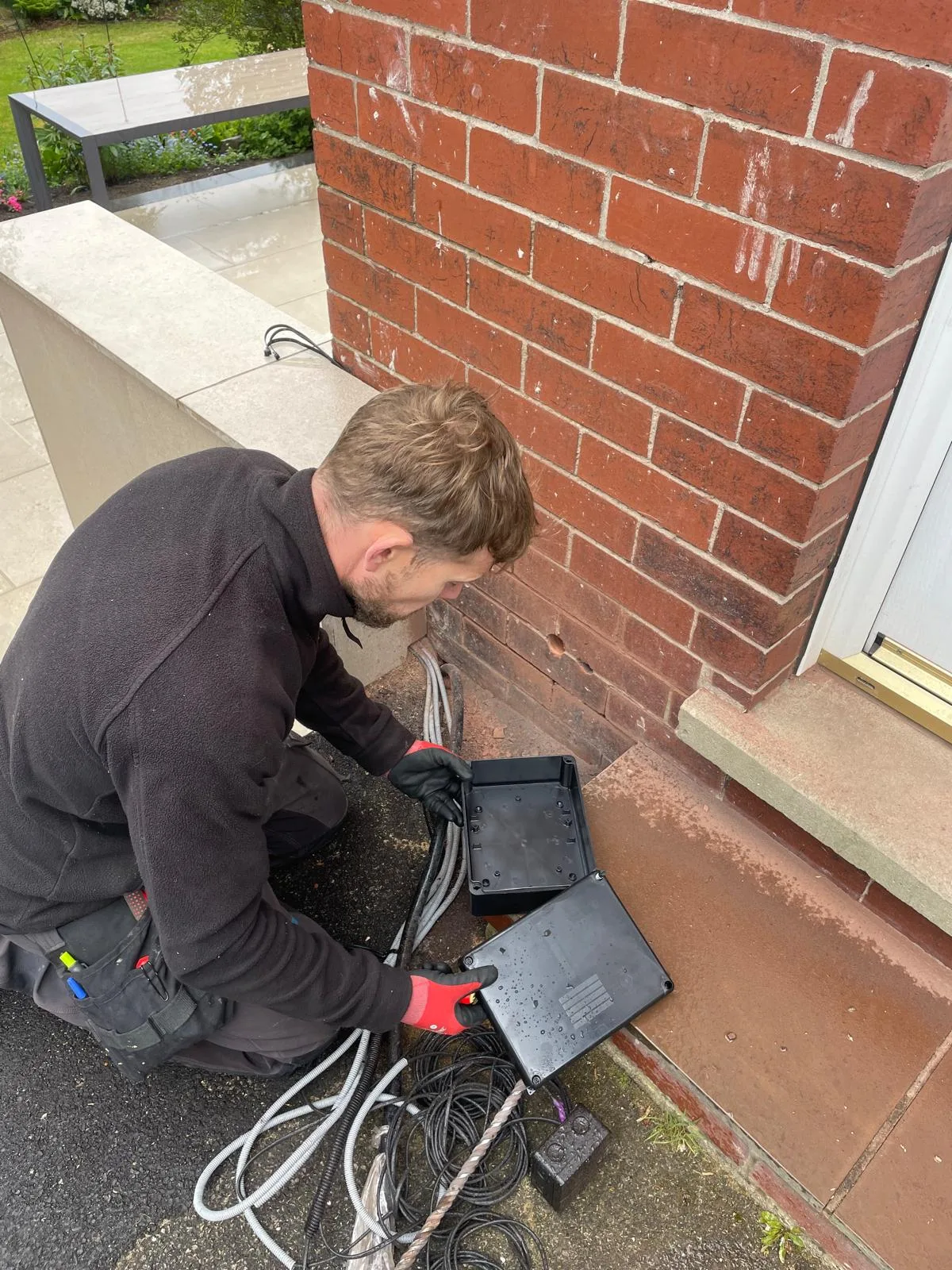 Weatherproof outdoor junction box and cabling for a garden room electrical installation in Hyde