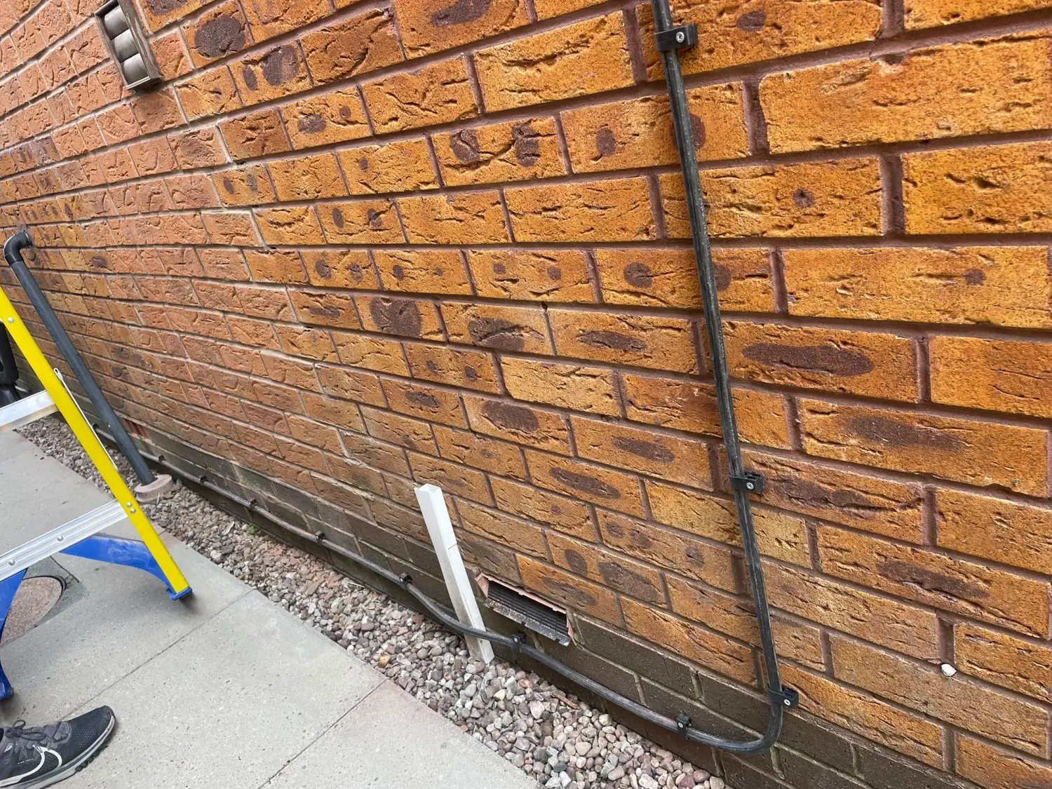 4mm steel-wire-armoured (SWA) cable clipped direct along an external wall in Glossop, running the new air conditioning power supply