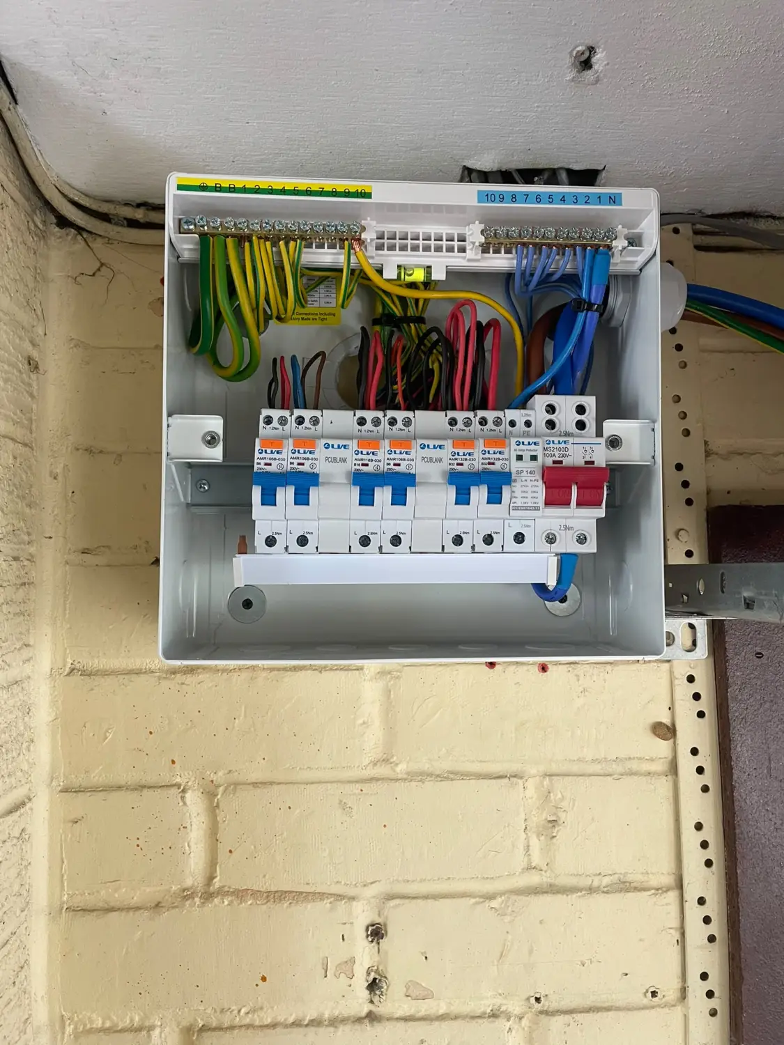 The new RCBO consumer unit during installation in Chadderton — individual RCBOs, a surge protection device and neatly dressed wiring