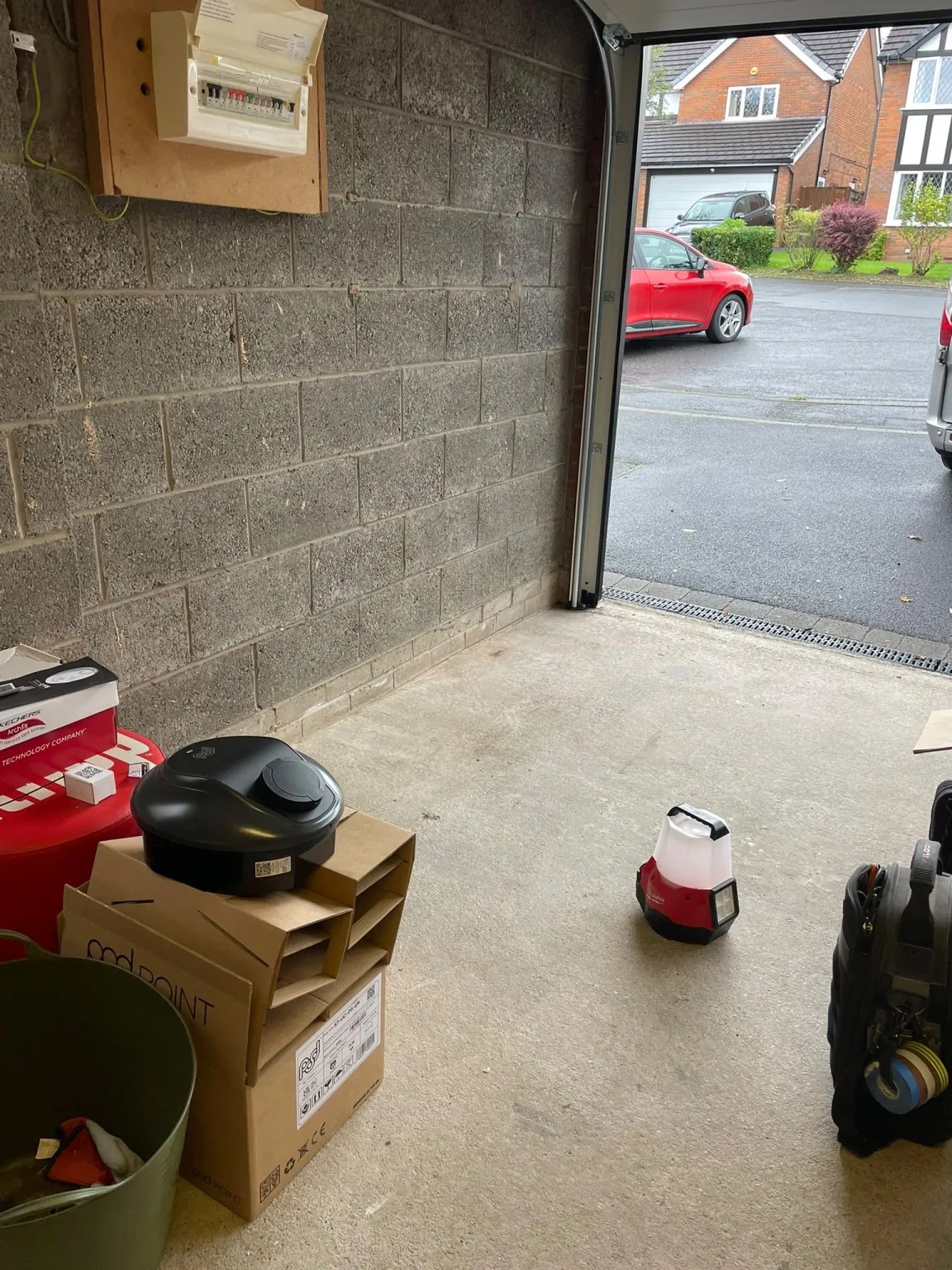 Pod Point Solo 3 charge point and packaging on the floor of a Marple garage at the start of the EV charger installation